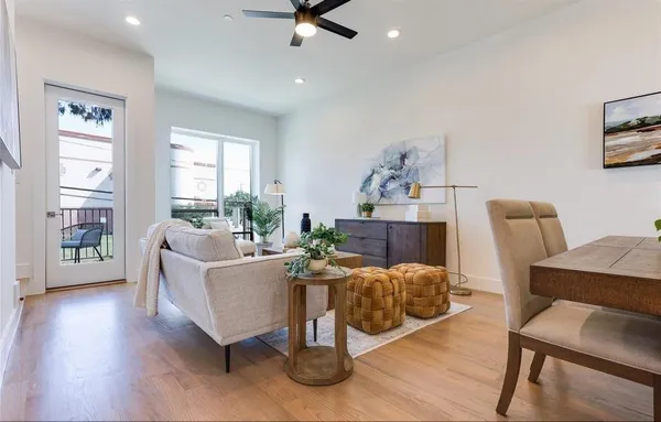 a living room with furniture a wooden floor and a window