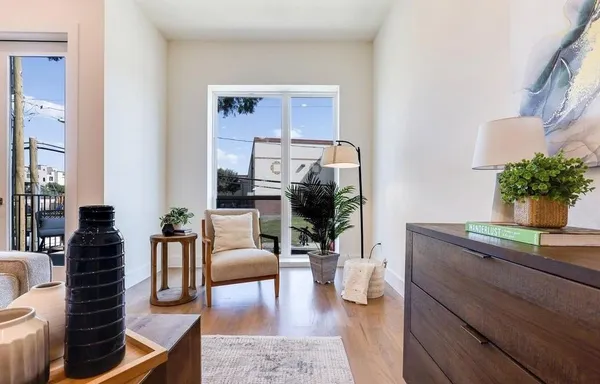 a living room with furniture and a potted plant