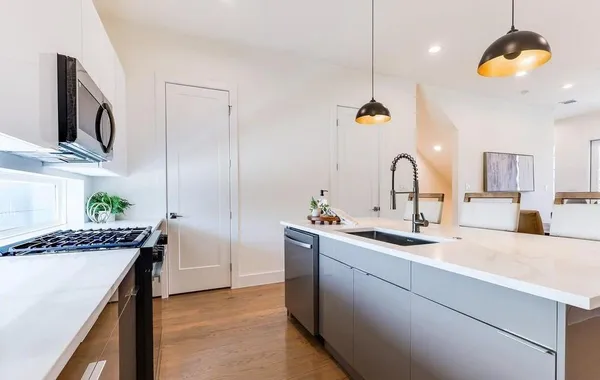 a kitchen with sink and cabinets