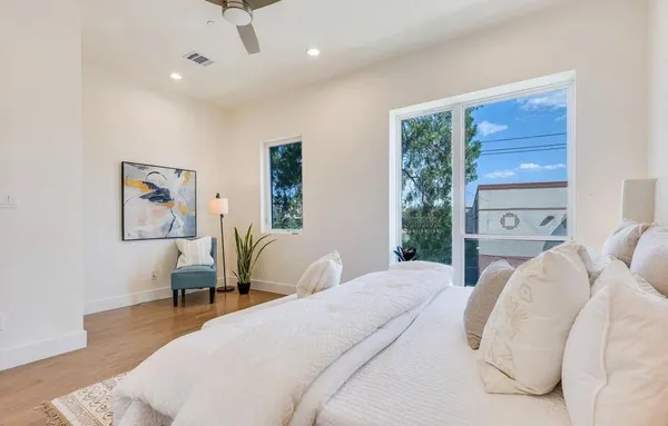 a bedroom with a large bed couch and a window