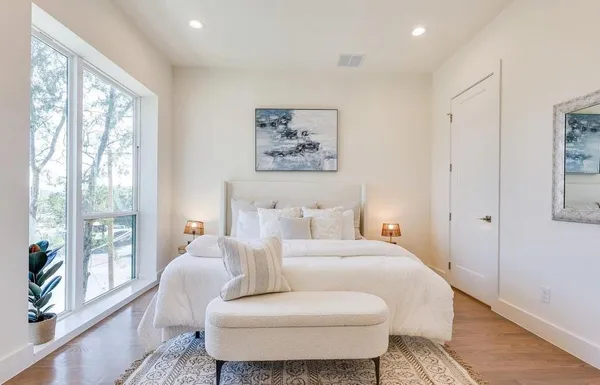 a room with a bed and wooden floor