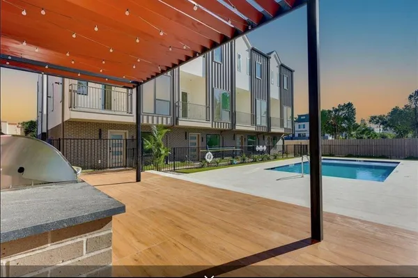 a view of a living room and kitchen with furniture