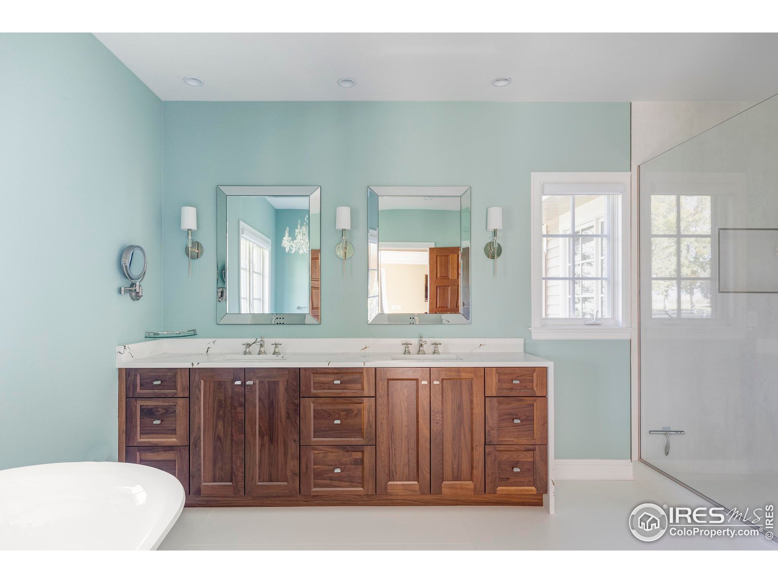 9402 Crystal Lane Longmont, CO 80503 - Photo 18 of 32 a spacious bathroom with a granite countertop sink a mirror and a bathtub
