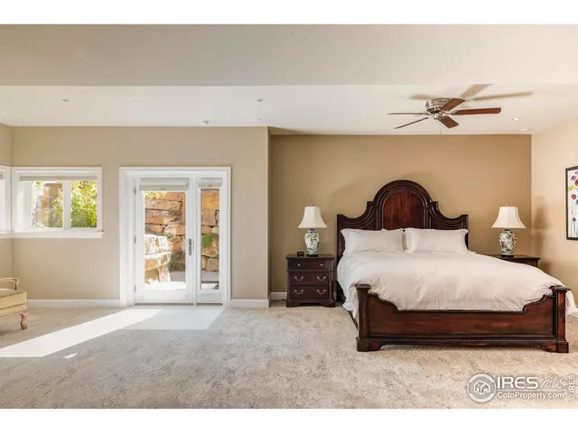 a bedroom with a large bed and a chandelier