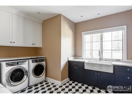 a utility room with sink dryer and washer