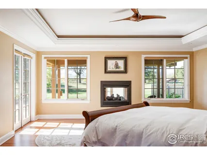 a bedroom with a large bed and a fireplace