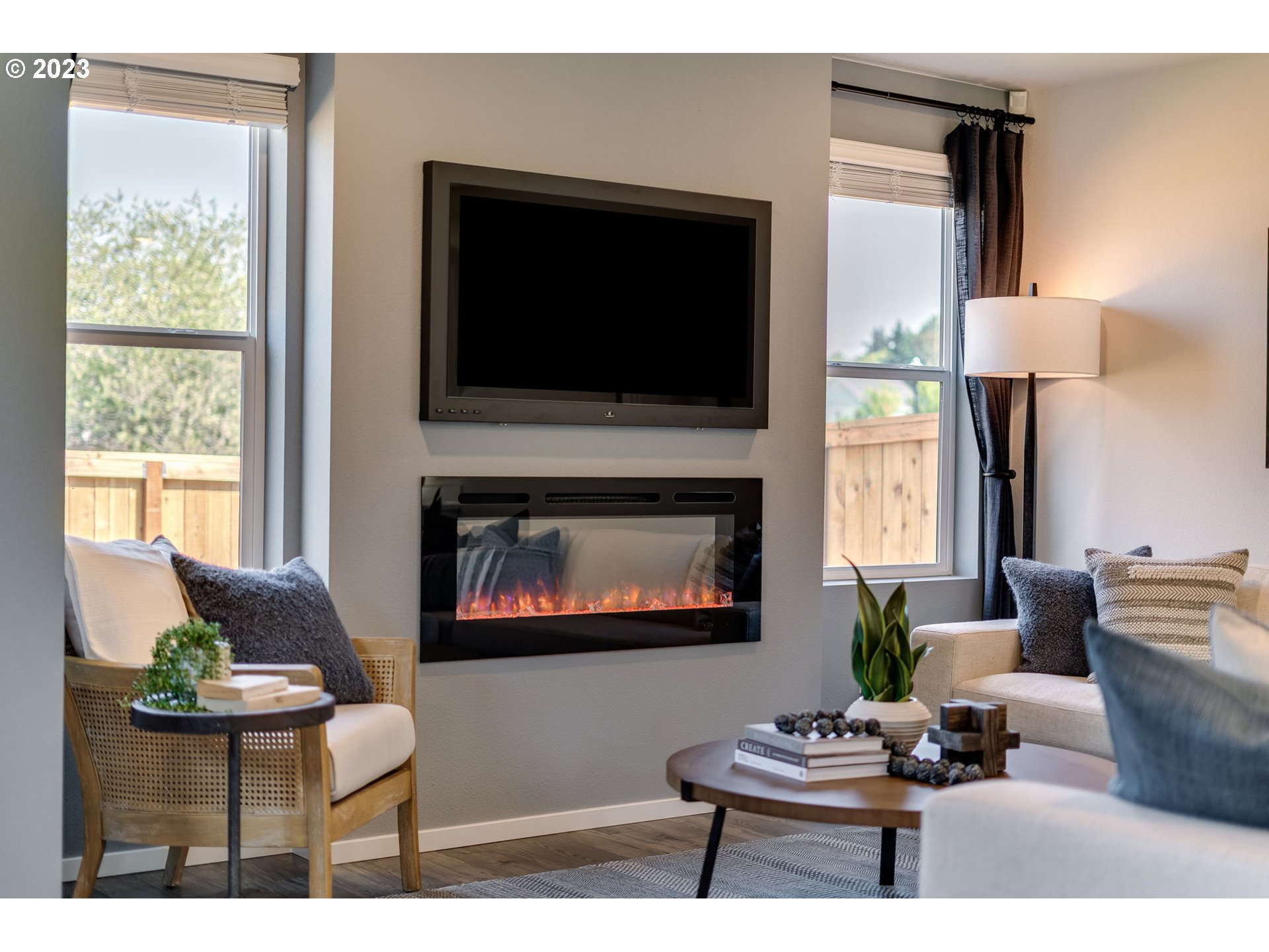 203 North Layla Place Ridgefield, WA 98642 - Photo 11 of 30 a living room with furniture a flat screen tv and a fireplace