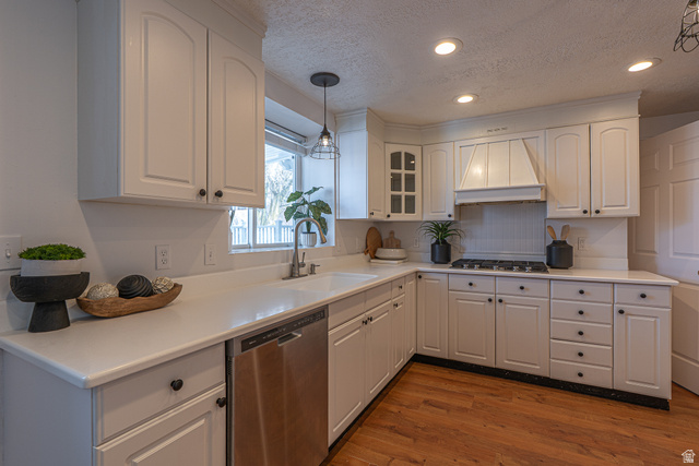1045 Fox Farm Road Logan, UT 84321 - Photo 17 of 65 Kitchen featuring appliances with stainless steel finishes, a textured ceiling, light countertops, custom exhaust hood, and dark wood finished floors
