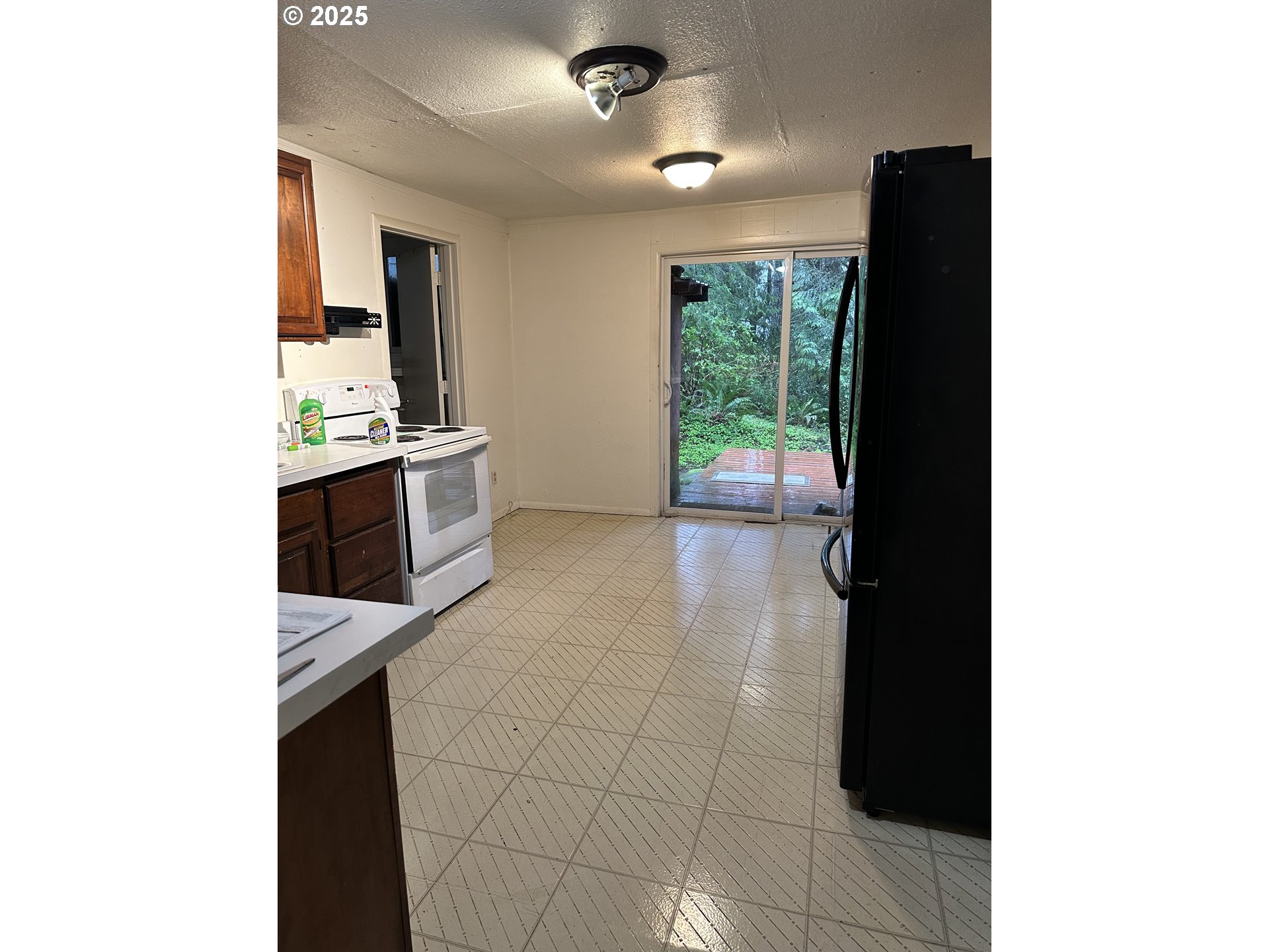 9247 Highway 126 Mapleton, OR 97453 - Photo 10 of 41 a kitchen with stainless steel appliances a refrigerator and a stove top oven
