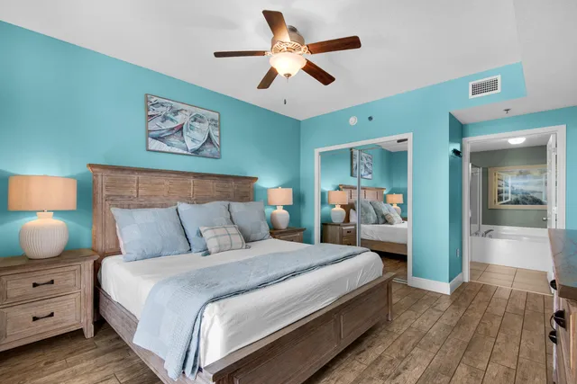 a bedroom with bed and wooden floor