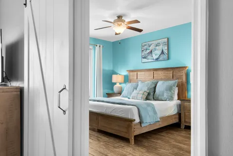 a bedroom with a bed and a chandelier