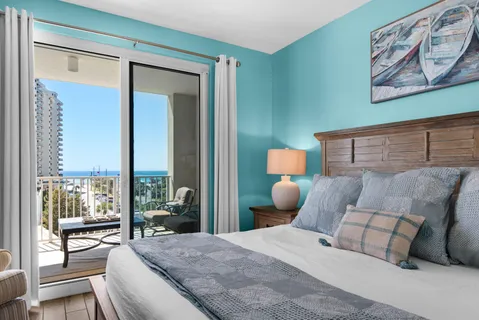 a bedroom with a large bed and a large window