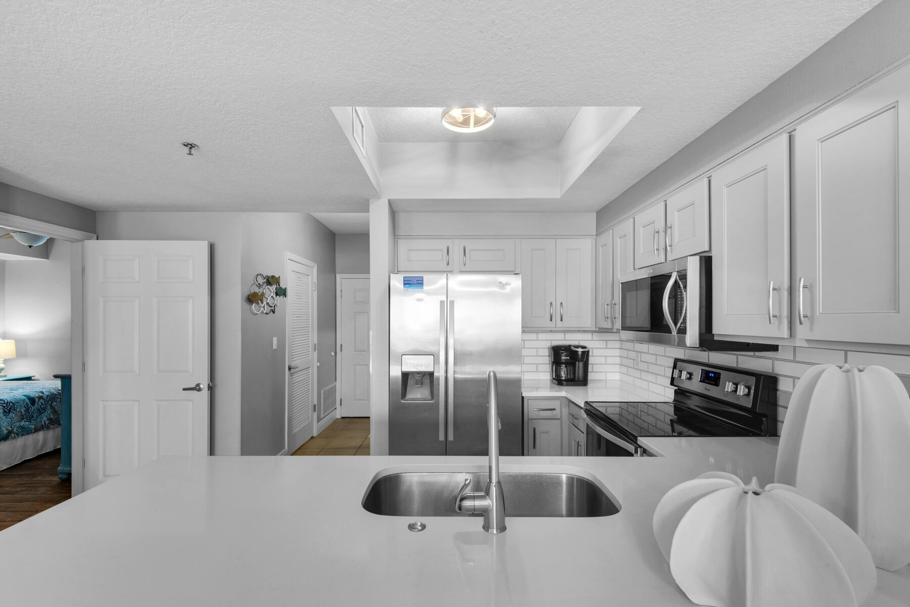 112 Seascape Drive, Unit 402 Miramar Beach, FL 32550 - Photo 2 of 31 a kitchen with stainless steel appliances a refrigerator a sink a stove a microwave a counter top space and cabinets