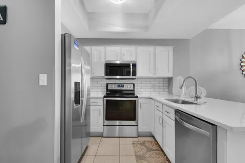 a kitchen with a sink and stainless steel appliances
