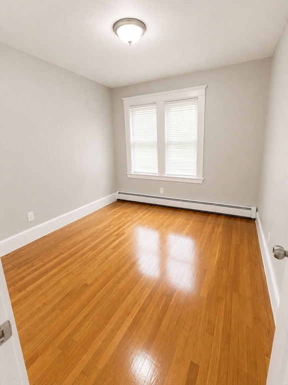 196 Washington Street, Unit 2 Lynn, MA 01902 - Photo 4 of 4 an empty room with wooden floor and windows
