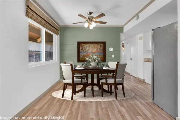 a view of a dining room with furniture and wooden floor