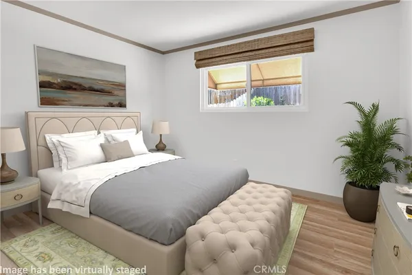 a bedroom with a bed and a potted plant