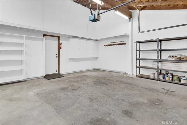 an aerial view of a house with table and chairs