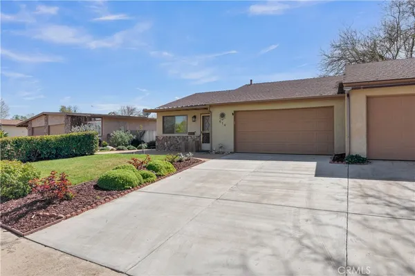 a front view of a house with garden