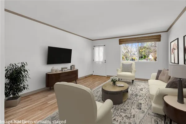 a living room with furniture a window and a flat screen tv