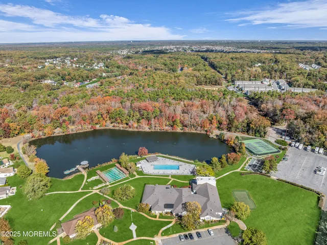 an aerial view of residential houses with outdoor space and swimming pool