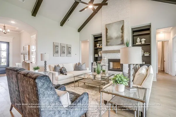 a living room with fireplace furniture and a wooden floor