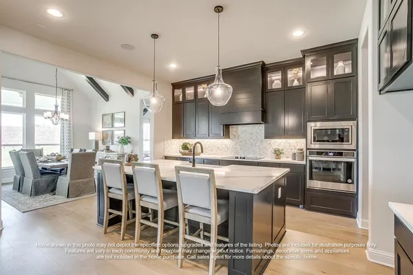 a large kitchen with a table and chairs