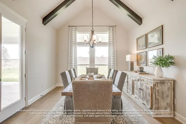 a dining room with furniture a rug and a large window