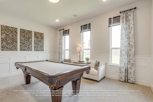 a room with pool table and windows