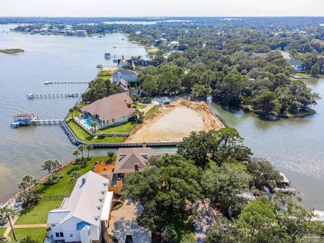 an aerial view of a house with outdoor space and lake view