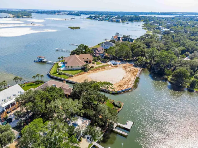 an aerial view of a house with outdoor space and lake view