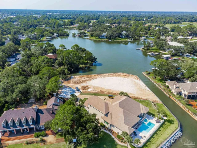 an aerial view of lake and residential houses with outdoor space