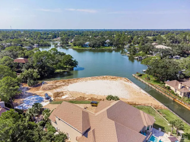 an aerial view of residential houses with outdoor space and river
