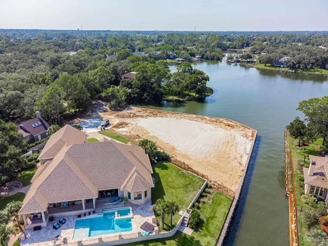 an aerial view of house with yard and lake view
