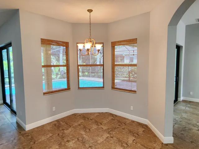 a kitchen with granite countertop a refrigerator and a sink