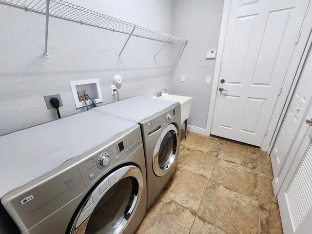 a front view of a house with a yard and fountain in middle