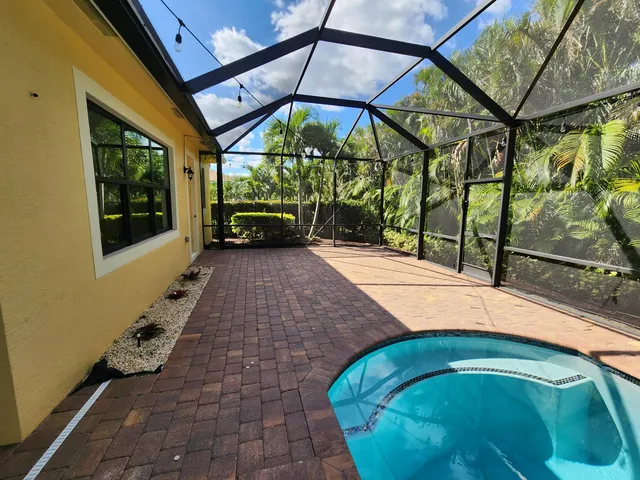 a view of a hallway with wooden floor and a window