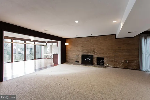 an empty room with furniture and a fireplace
