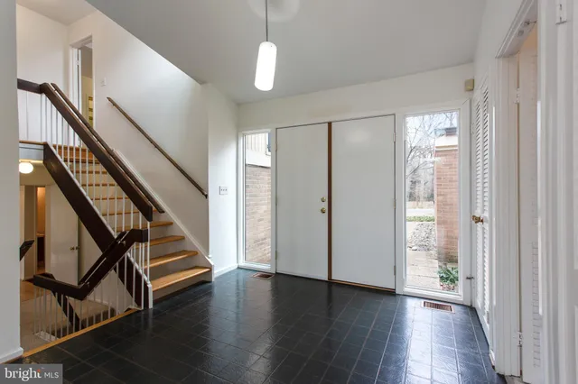 a view of an entryway with wooden floor and stairs