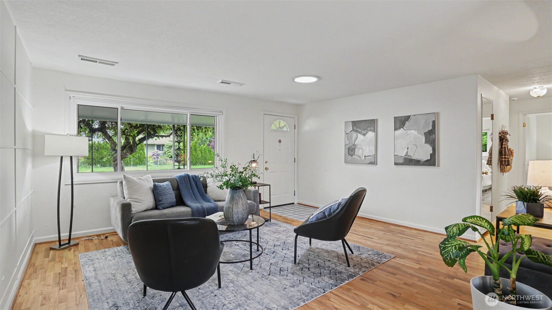 12515 Southeast 171st Street Renton, WA 98058 - Photo 5 of 24 a living room with furniture and a potted plant