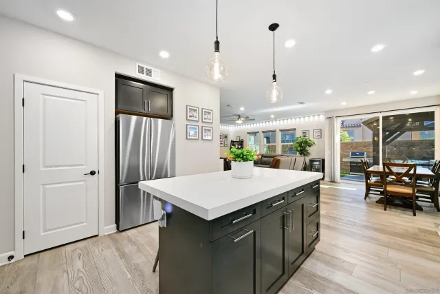 a large kitchen with a table and chairs