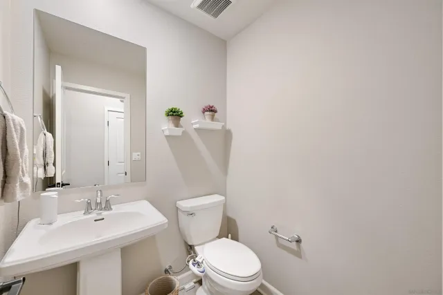 a white toilet sitting next to a bathroom sink