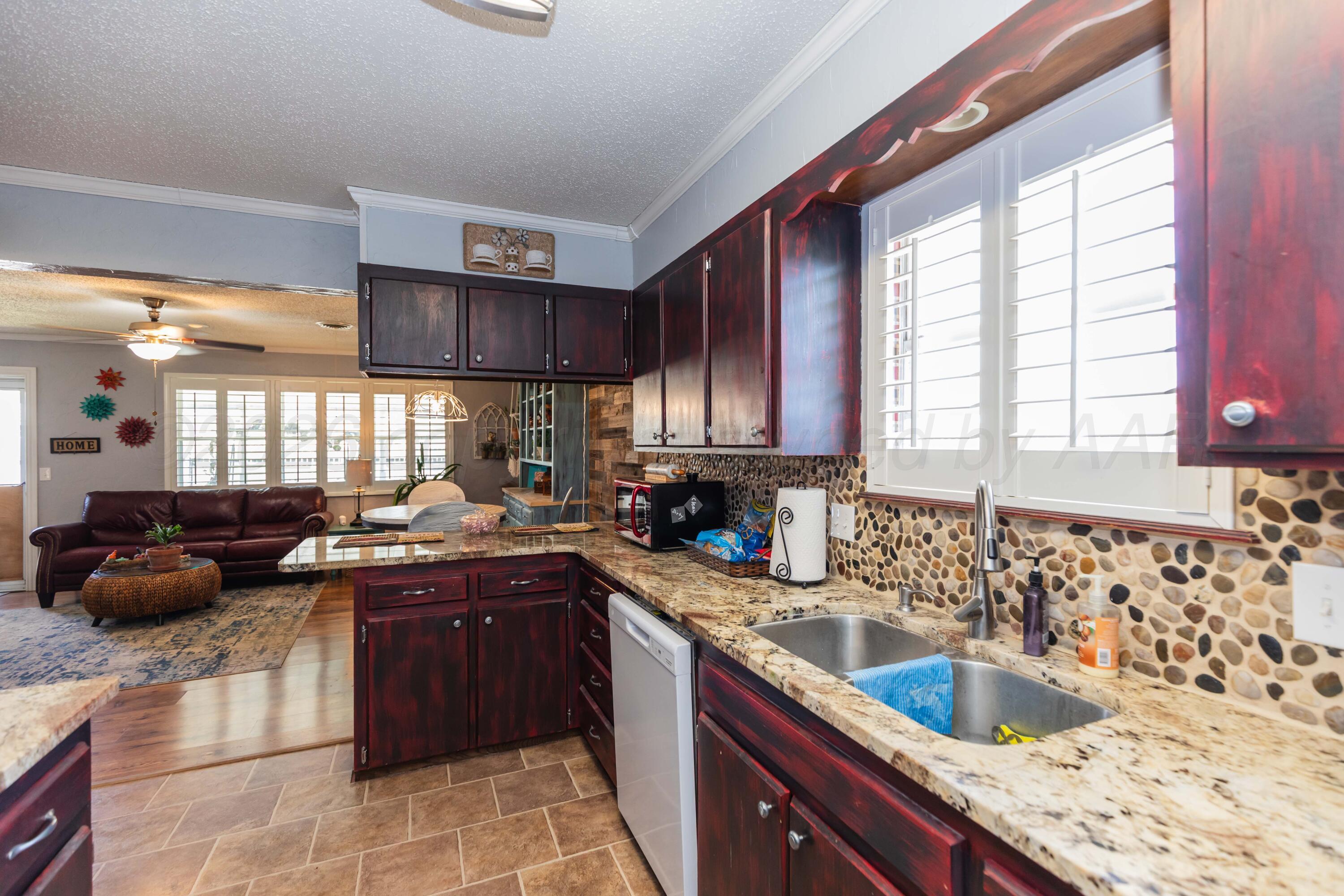 4800 South Austin Street Amarillo, TX 79110 - Photo 12 of 29 a kitchen with a sink stove and cabinets