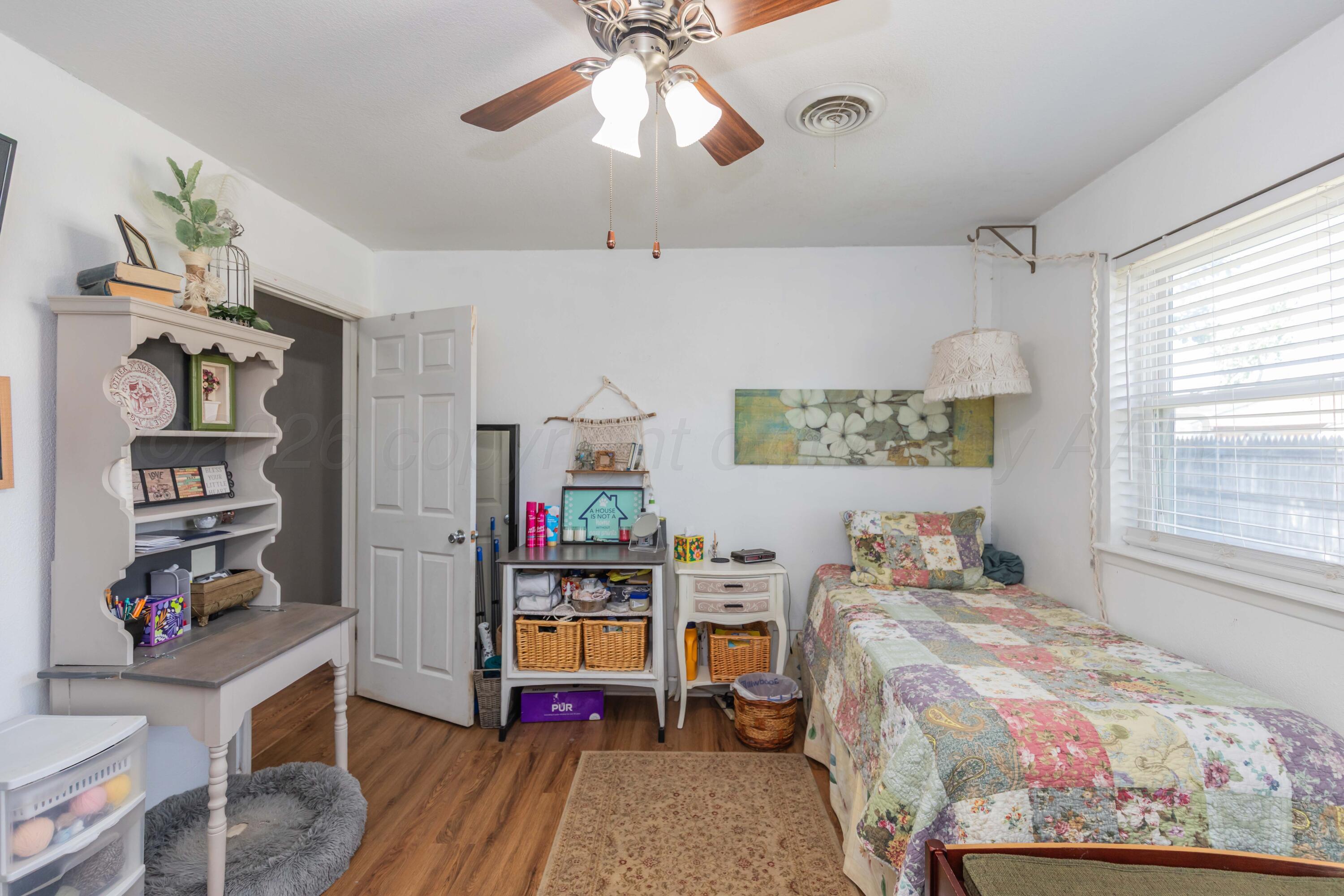 4800 South Austin Street Amarillo, TX 79110 - Photo 16 of 29 a bed room with a bed and a window