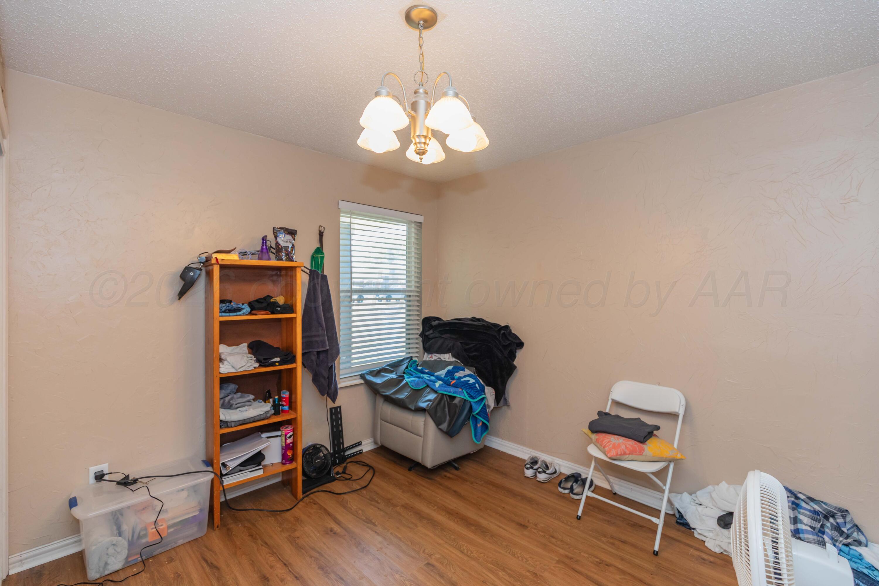 4800 South Austin Street Amarillo, TX 79110 - Photo 19 of 29 a living room with furniture and a wooden floor