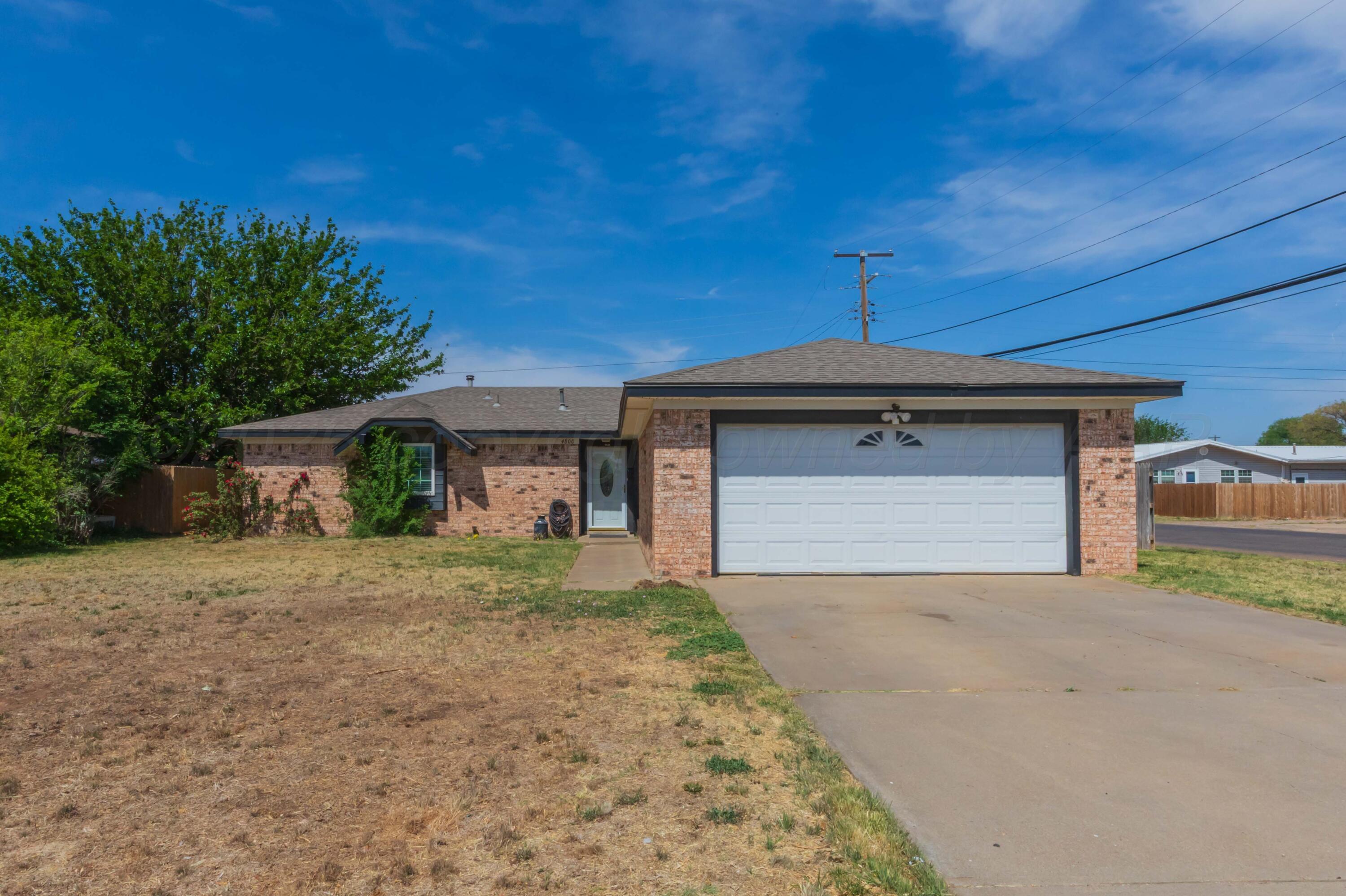 4800 South Austin Street Amarillo, TX 79110 - Photo 2 of 29 a front view of a house with a yard and garage