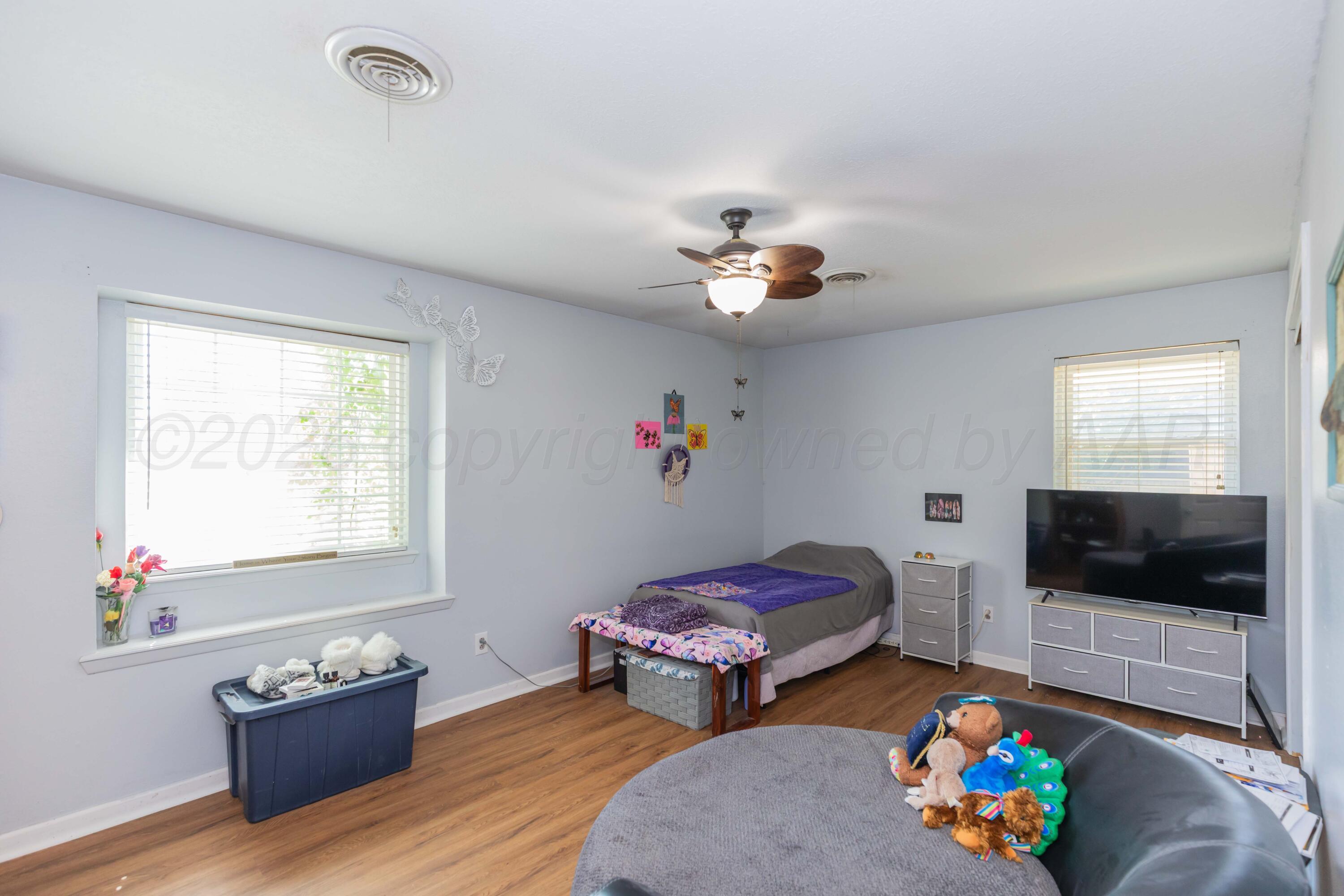 4800 South Austin Street Amarillo, TX 79110 - Photo 22 of 29 a bedroom with furniture and a flat screen tv