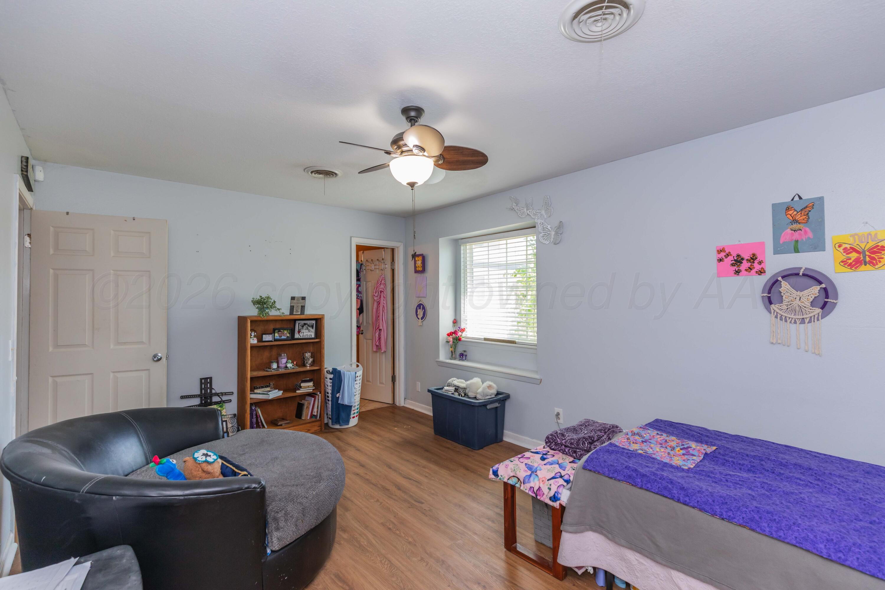 4800 South Austin Street Amarillo, TX 79110 - Photo 24 of 29 a living room with furniture and a flat screen tv