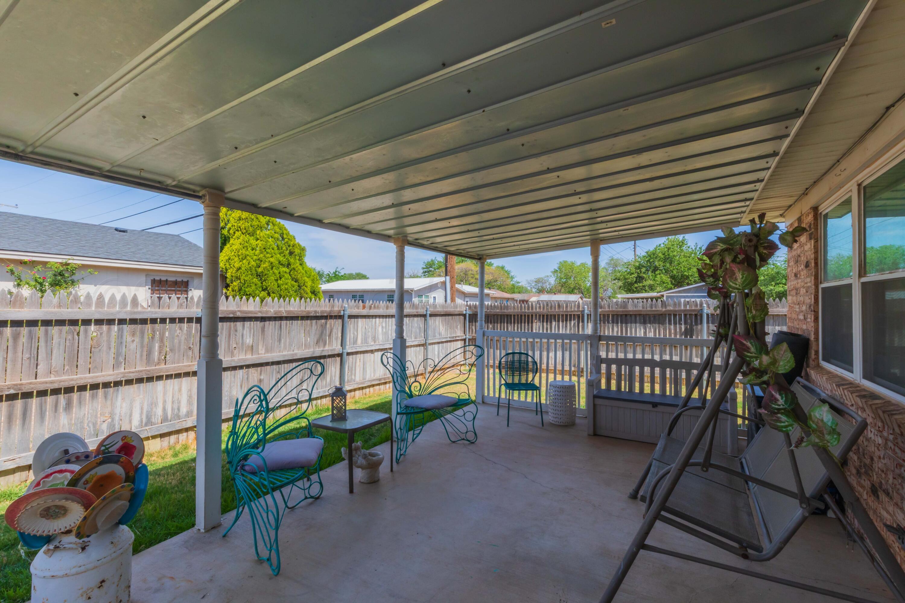 4800 South Austin Street Amarillo, TX 79110 - Photo 26 of 29 a view of a deck with table and chairs with wooden fence