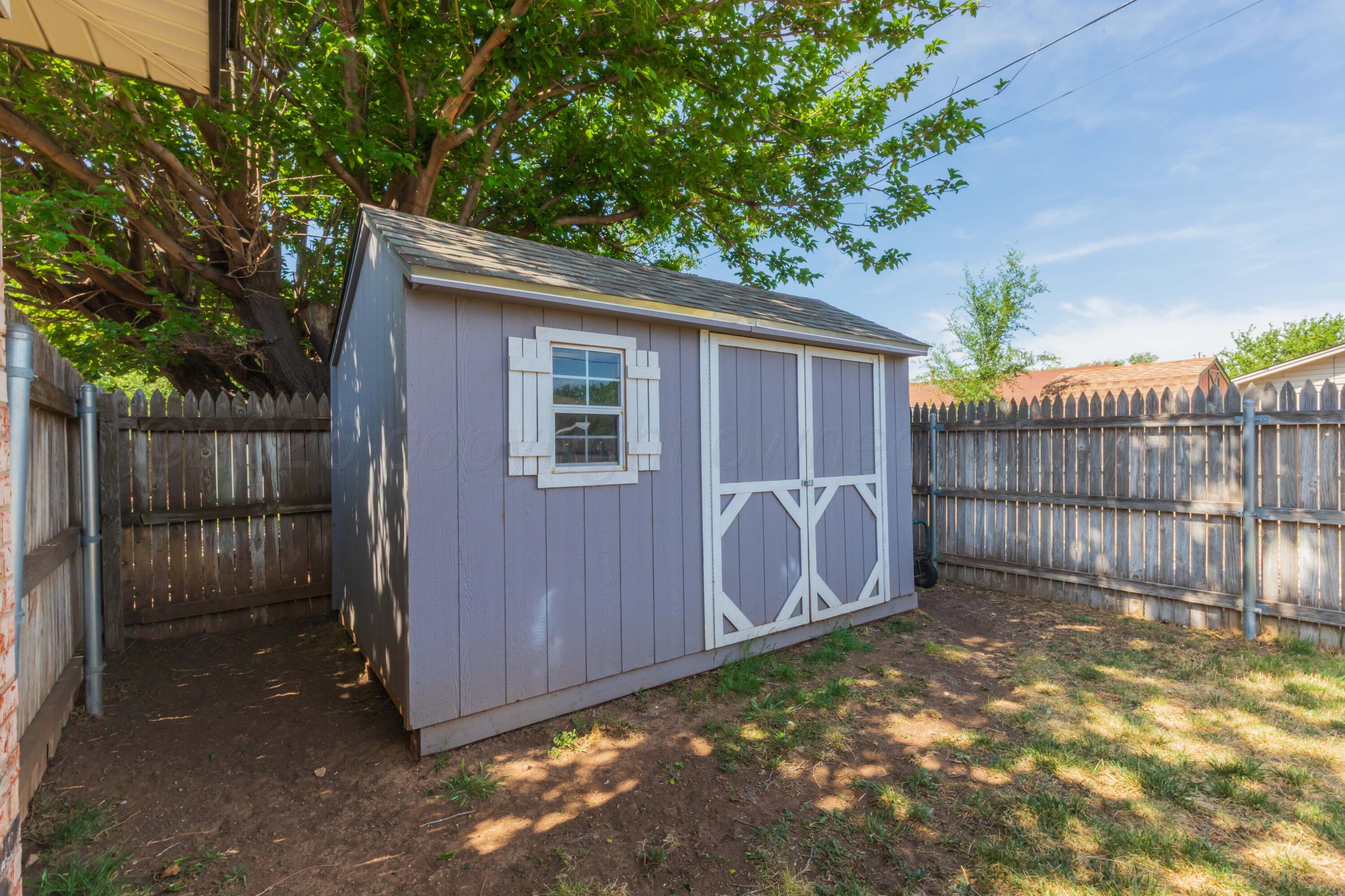 4800 South Austin Street Amarillo, TX 79110 - Photo 29 of 29 a view of backyard with wooden fence and large trees